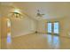 Open living room with arched ceilings, tile floors, and access to the outdoors at 105 Shaddock Dr, Auburndale, FL 33823