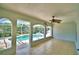 Enclosed porch features tile flooring and large windows offering a view of the pool area at 105 Shaddock Dr, Auburndale, FL 33823