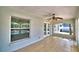 Enclosed porch featuring tile flooring, ceiling fan, windows, and open doorway at 105 Shaddock Dr, Auburndale, FL 33823