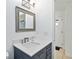 Bathroom featuring gray cabinets, quartz countertops, and modern fixtures at 11 Silver Falls Cir, Kissimmee, FL 34743