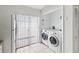 Convenient laundry area featuring washer, dryer and built in shelves at 11 Silver Falls Cir, Kissimmee, FL 34743