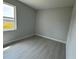 Bright, airy bedroom features a large window and wood-look floors at 113 Dogwood Drive Circle, Ocala, FL 34472