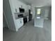 Modern kitchen featuring stainless steel appliances, an island and white cabinetry at 113 Dogwood Drive Circle, Ocala, FL 34472