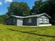 Exterior side view of the home featuring well maintained lawn and vibrant grass at 1225 Nemeth St, Auburndale, FL 33823