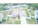 Aerial view of the home showcasing well-maintained landscaping, white fencing, and convenient driveway access at 125 Inconnu Ct, Poinciana, FL 34759