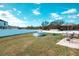 Backyard featuring a white fence, above-ground pool, patio seating, and lush green grass at 125 Inconnu Ct, Poinciana, FL 34759