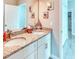 Bathroom featuring double vanity, granite counters, neutral wall color, and tiled floors at 125 Inconnu Ct, Poinciana, FL 34759