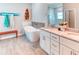 Modern bathroom features a soaking tub, granite counters, double sinks and beach themed decorations at 125 Inconnu Ct, Poinciana, FL 34759