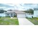 Charming home with well kept lawn, with two car garage, and white picket fence at 125 Inconnu Ct, Poinciana, FL 34759