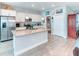 Well-lit kitchen featuring granite countertops, stainless steel appliances, and a central island with a sink at 125 Inconnu Ct, Poinciana, FL 34759