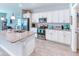 Modern kitchen showcasing white cabinets, granite countertops, and stainless steel appliances at 125 Inconnu Ct, Poinciana, FL 34759