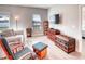 Cozy living room with tiled flooring, bright window, and comfortable seating furniture at 125 Inconnu Ct, Poinciana, FL 34759