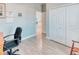 Spacious office area featuring tiled floors, natural lighting, and a closet with a mirrored door at 125 Inconnu Ct, Poinciana, FL 34759