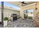 A covered back patio featuring a grill, ceiling fan and paver stones at 1368 Berry Ln, Davenport, FL 33837