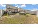 A beautiful view of a backyard featuring a trampoline and dark metal and vinyl fencing at 1368 Berry Ln, Davenport, FL 33837