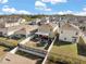 A beautiful view of a backyard featuring a trampoline, covered patio, and dark metal and vinyl fencing at 1368 Berry Ln, Davenport, FL 33837