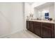 Bright bathroom features double sinks and vanity, with a shower-tub combination, offering convenience and style at 1368 Berry Ln, Davenport, FL 33837