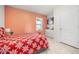 Cozy bedroom with a bright coral wall and tile floors at 1368 Berry Ln, Davenport, FL 33837