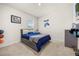 Comfortable bedroom featuring neutral carpet, a bed with storage, and a decorative gaming theme at 1368 Berry Ln, Davenport, FL 33837