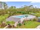 A refreshing community pool surrounded by lush landscaping and lounge chairs at 1368 Berry Ln, Davenport, FL 33837