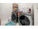 Laundry room with modern washer and dryer units and ample storage space at 1368 Berry Ln, Davenport, FL 33837