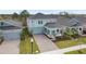 Aerial view of a two-story home with a brick paver driveway and professional landscaping at 139 Aces High Ln, Davenport, FL 33896