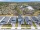 Aerial view of homes with a pond in the background and lush landscaping at 139 Aces High Ln, Davenport, FL 33896