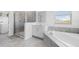 Spacious bathroom with a walk-in shower, garden tub, neutral tile and countertops at 139 Aces High Ln, Davenport, FL 33896