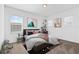 Cozy bedroom featuring neutral tones, plush bedding, and a built-in desk area with natural light at 139 Aces High Ln, Davenport, FL 33896
