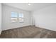 Sunlit bedroom showcasing neutral carpet, light walls, and a view through the bright windows at 139 Aces High Ln, Davenport, FL 33896