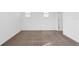 A bright, empty bedroom with neutral carpeting and ample natural light from two windows at 139 Aces High Ln, Davenport, FL 33896