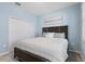 Bedroom features modern furnishings, neutral carpeting, and light blue walls at 139 Aces High Ln, Davenport, FL 33896
