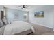 Comfortable bedroom with calming color palette, plush bedding, and mounted television at 139 Aces High Ln, Davenport, FL 33896