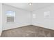 This bedroom has neutral carpet and paint and two windows at 139 Aces High Ln, Davenport, FL 33896