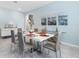 Stylish dining room with a white table, seating for six, modern decor, and large windows at 139 Aces High Ln, Davenport, FL 33896