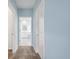 Hallway leading to a bright bathroom, featuring a view of the tub at 139 Aces High Ln, Davenport, FL 33896