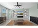 Bright living room featuring a modern entertainment center and a cozy area rug at 139 Aces High Ln, Davenport, FL 33896