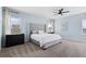Relaxing main bedroom features a plush bed, soft carpet, ceiling fan, and plenty of natural light at 139 Aces High Ln, Davenport, FL 33896
