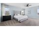 Spacious main bedroom with a comfortable bed, soft carpet, and a modern ceiling fan at 139 Aces High Ln, Davenport, FL 33896