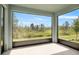 Enclosed patio offering serene views of the lush, green outdoors at 139 Aces High Ln, Davenport, FL 33896
