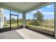 Enclosed patio overlooking tranquil backyard landscape and blue sky views at 139 Aces High Ln, Davenport, FL 33896