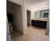 Bathroom with double sink vanity and tiled floor, with view into the toilet room and closet at 144 Bella Dr, Davenport, FL 33837