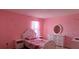 Bedroom featuring a bed, dresser, and pink walls at 144 Bella Dr, Davenport, FL 33837