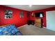 This bedroom features a TV, neutral carpet, and is finished with a vibrant red color scheme at 144 Bella Dr, Davenport, FL 33837