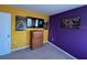 This bedroom features a TV, neutral carpet, yellow and purple color scheme, and pop-art style wall art at 144 Bella Dr, Davenport, FL 33837