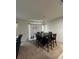 Dining room with a black table and chairs under a chandelier, next to a dark leather couch at 144 Bella Dr, Davenport, FL 33837