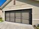 Close up of the garage with a three-car garage door at 144 Bella Dr, Davenport, FL 33837