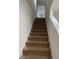 Carpeted staircase leading to the upper level of the home at 144 Bella Dr, Davenport, FL 33837