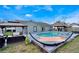 Inviting backyard pool with poolside lounge, hammock, covered seating, and mature landscaping at 1464 Howland Blvd, Deltona, FL 32738