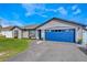 Charming single-Gathering home with a blue garage door, manicured lawn, and a walkway at 1464 Howland Blvd, Deltona, FL 32738